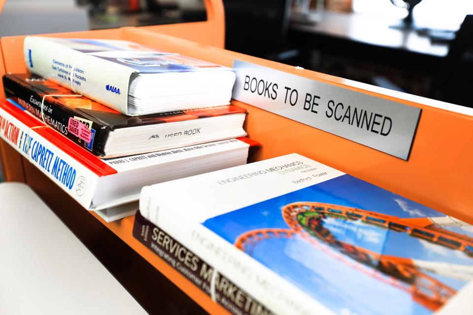 textbooks on a shelf ready to be scanned accessible
