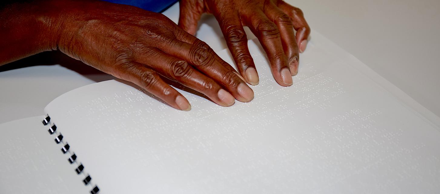 A woman's hands reading braille.