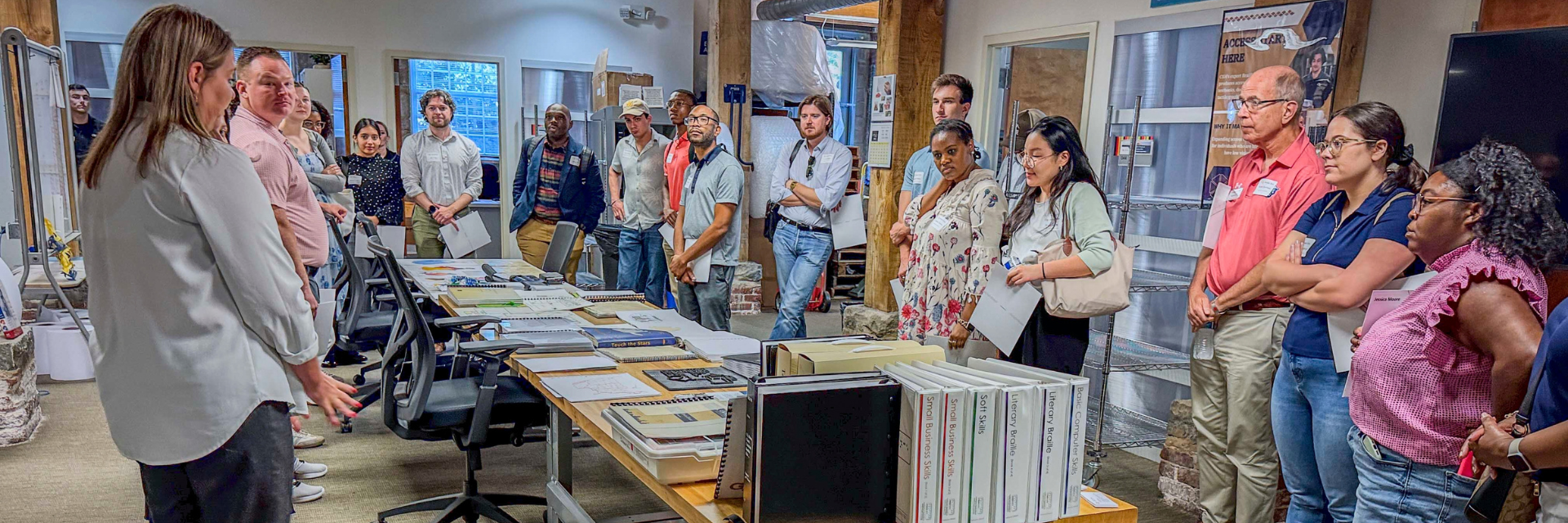 A group of congressional staffers learn about tactile media. 