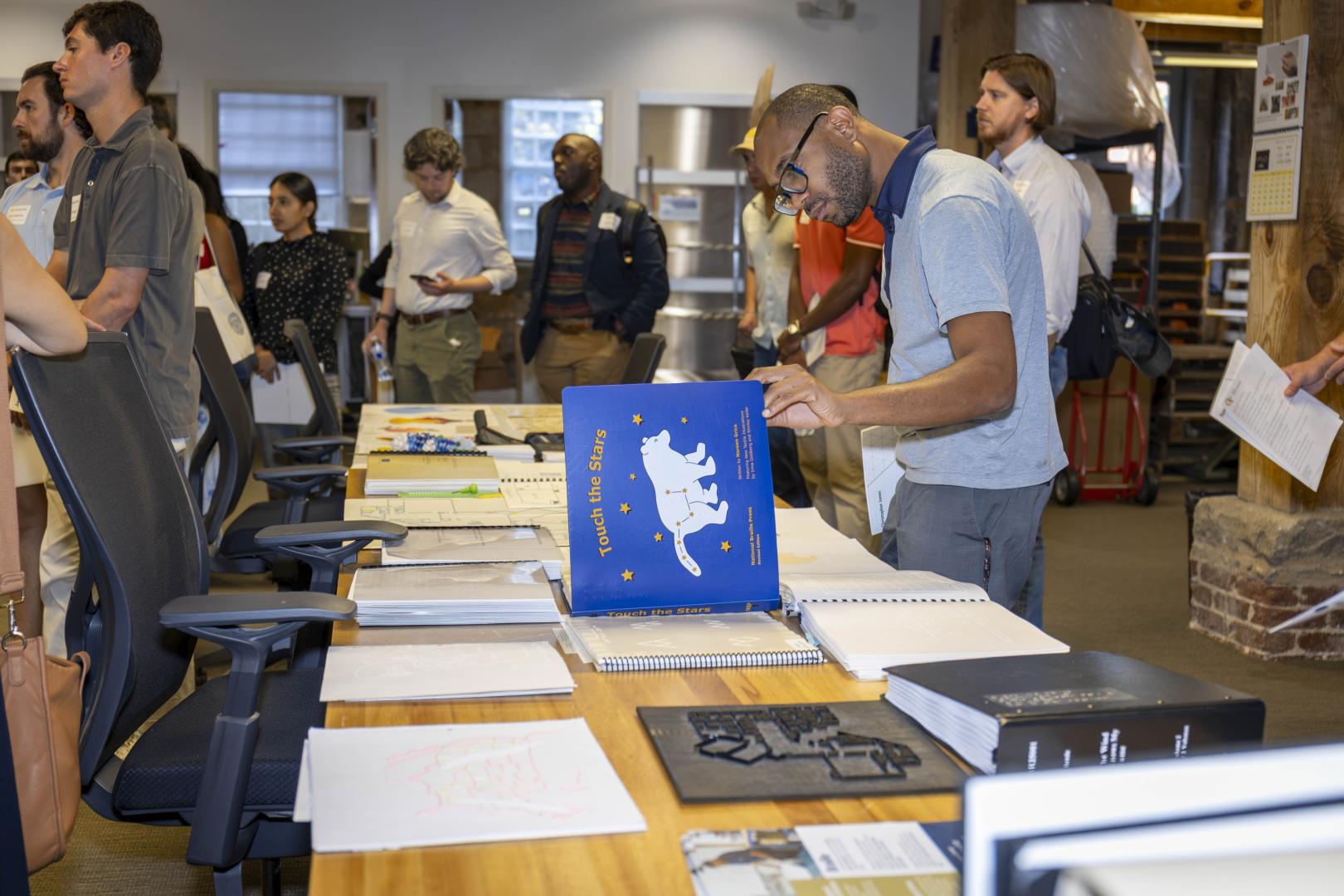 A staffer looking at tactile media. 