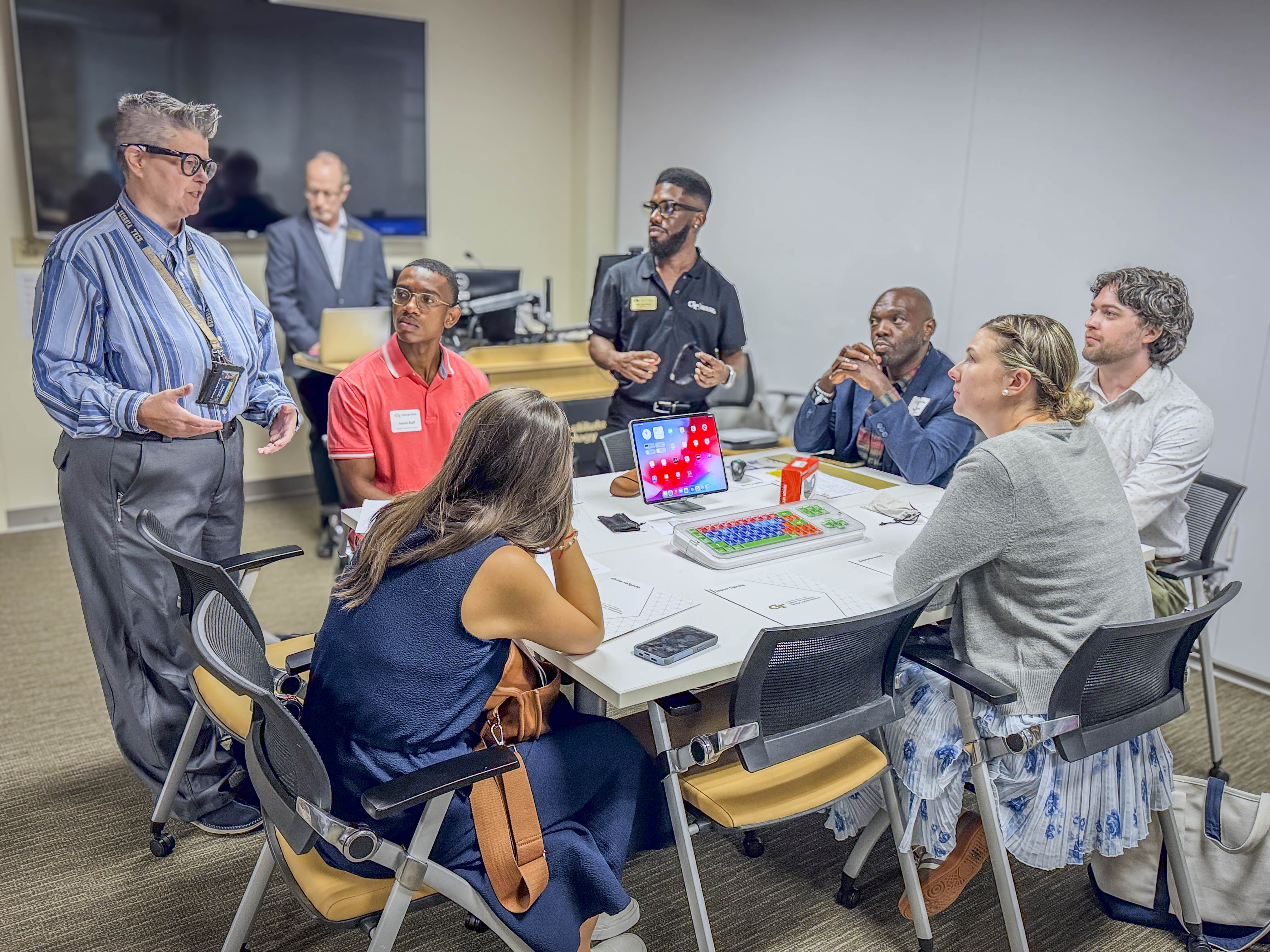 A group of staffers listening to a CIDI researcher. 
