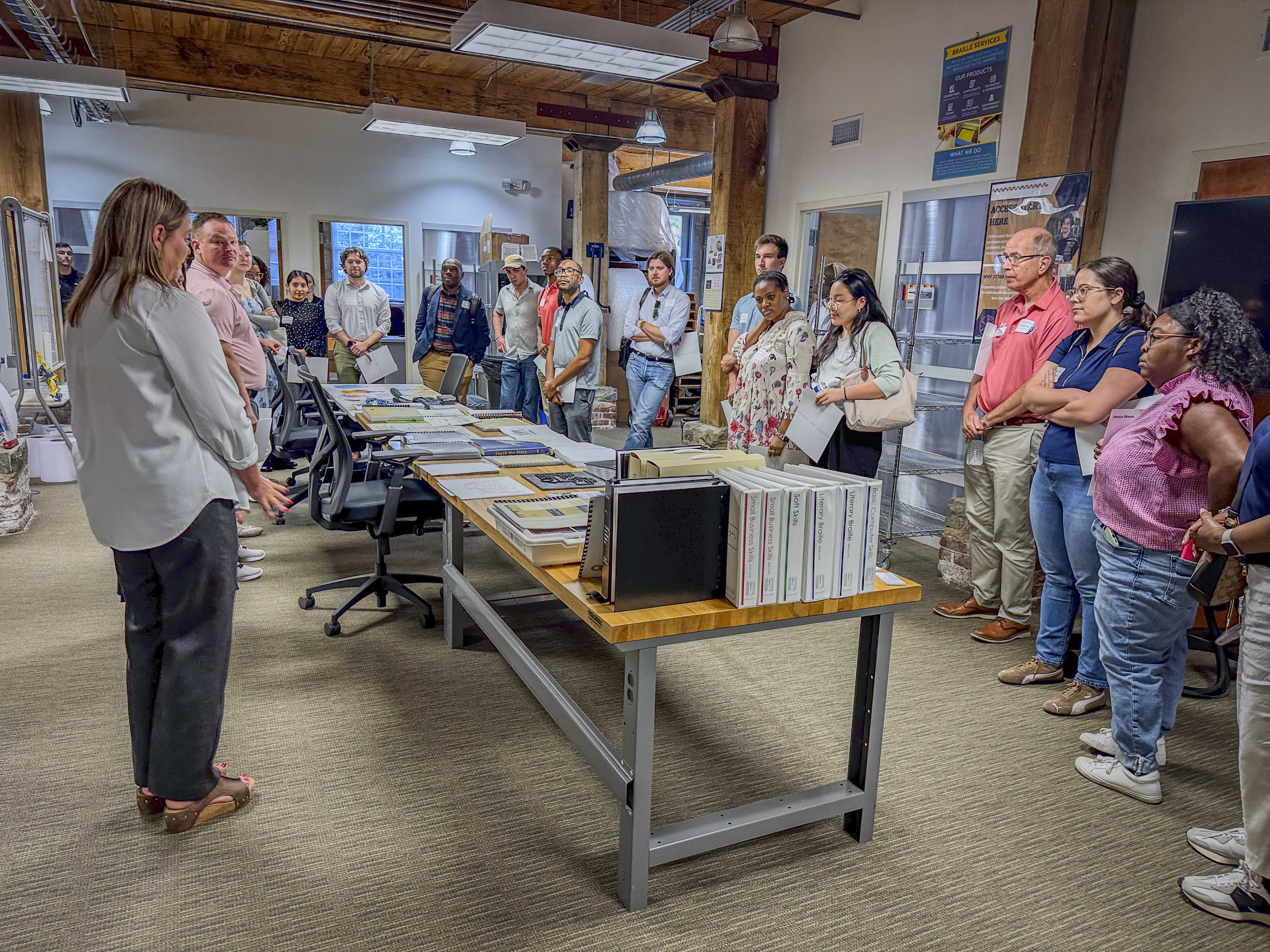 A group of staffers learning about tactile media and braille. 